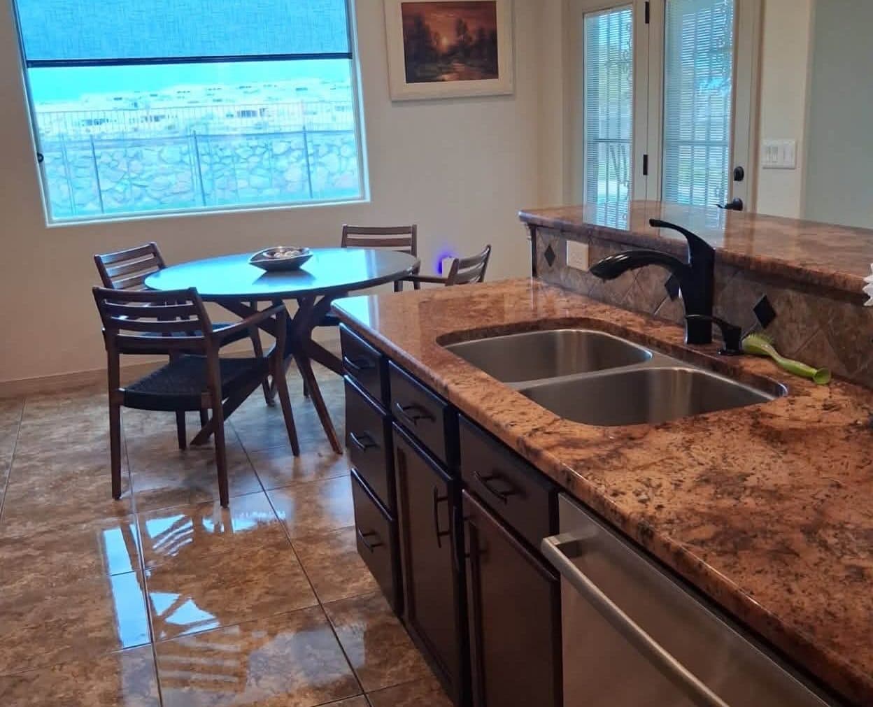 Kitchen with granite counters and a dining nook after a house cleaning