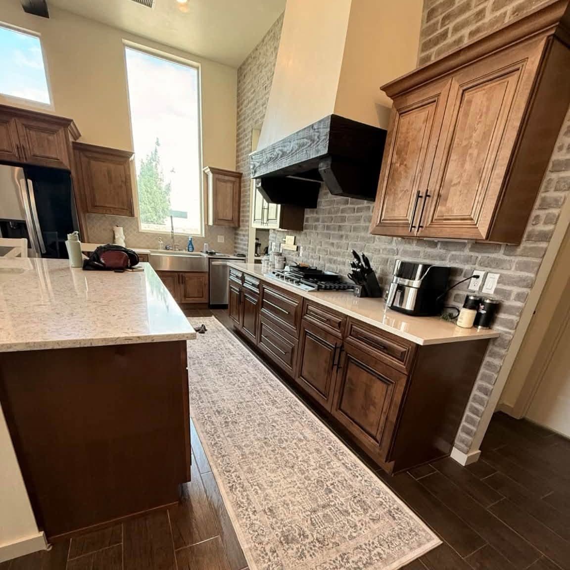 Kitchen with a large island and wood cabinets after a recurring house cleaning