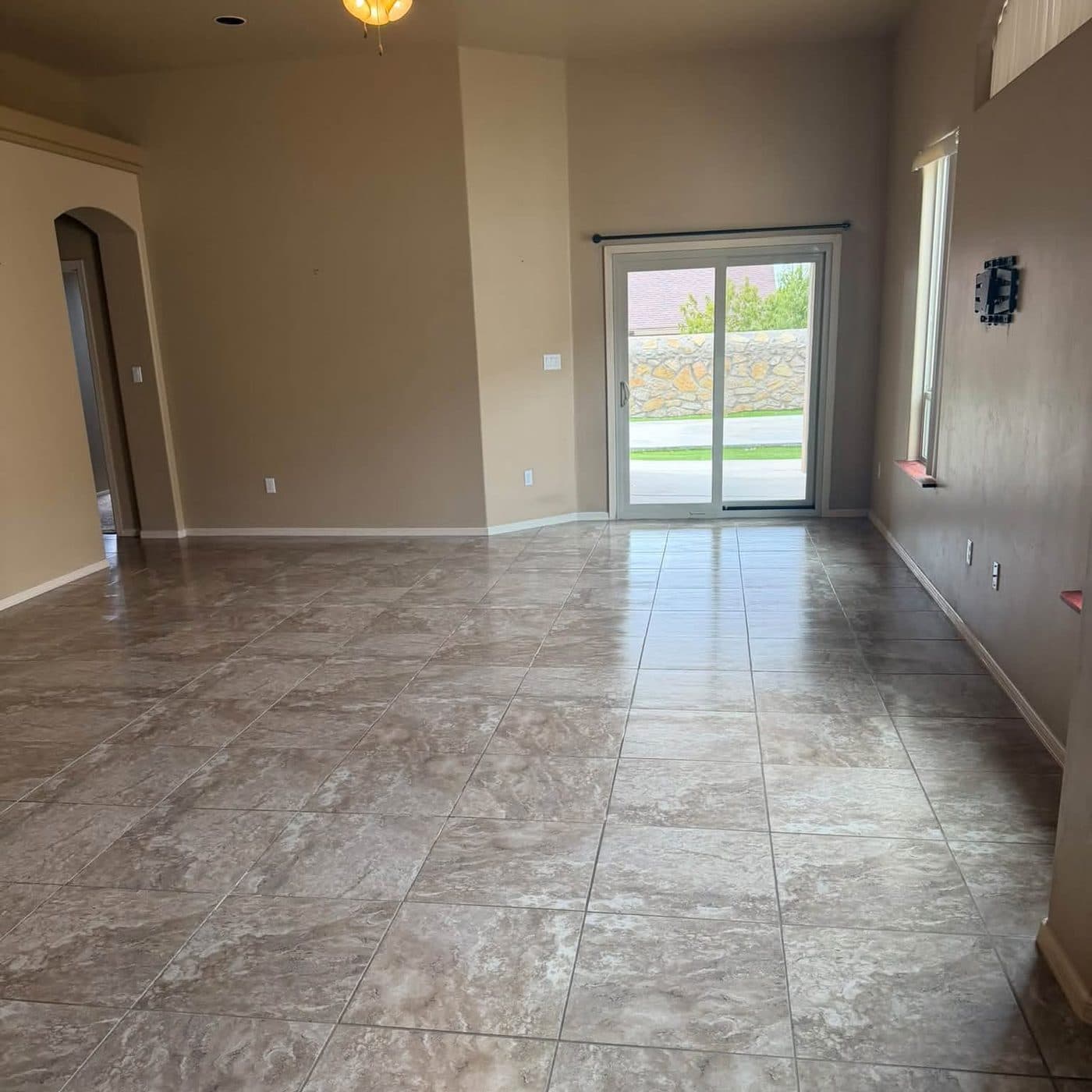 Empty living room with clean tile floors after a move-out cleaning