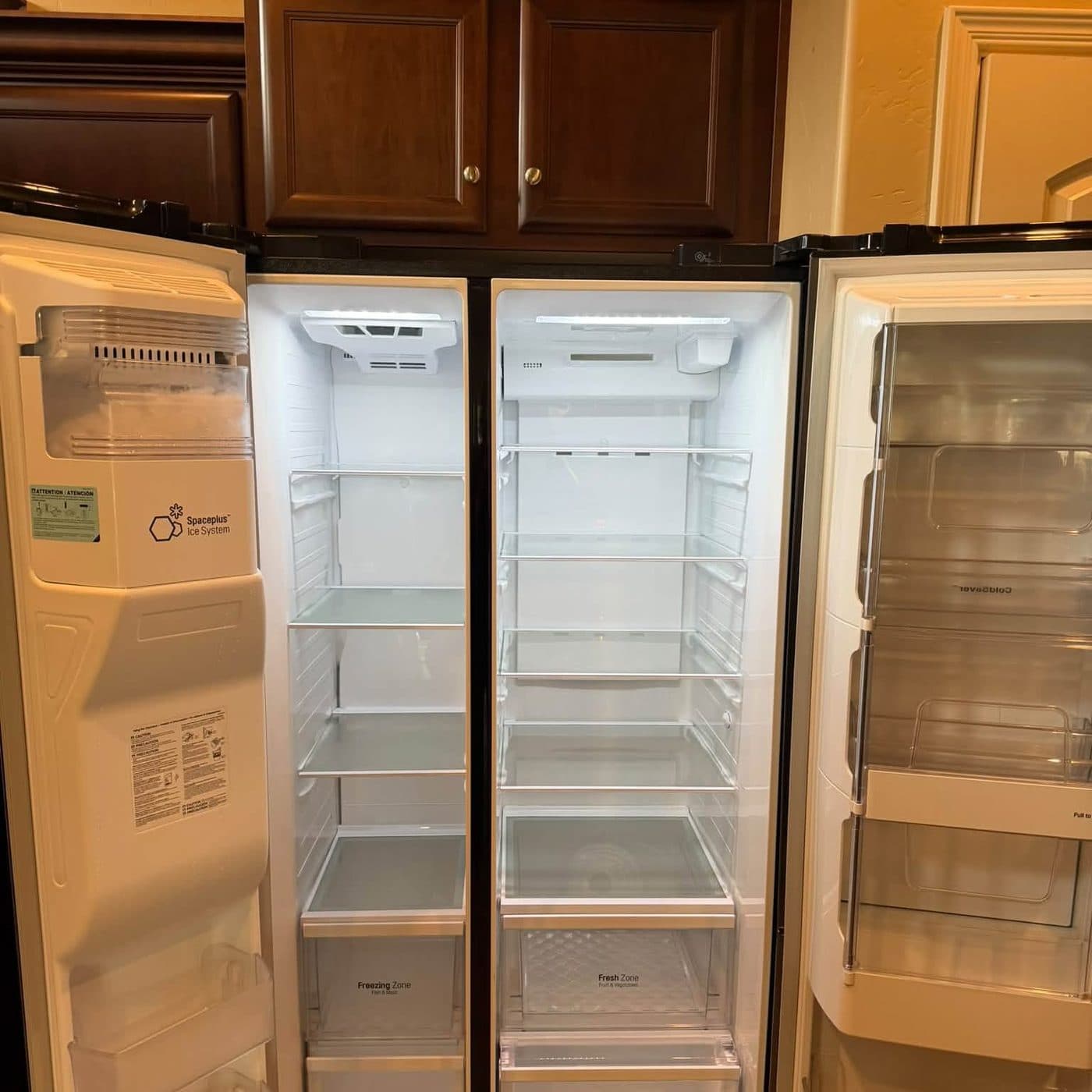 Empty refrigerator with clean shelves and door bins after a move-out cleaning