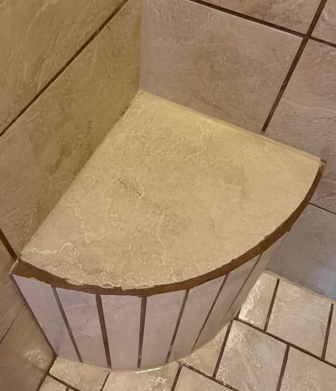 The same tiled shower bench, clean, after the deep cleaning